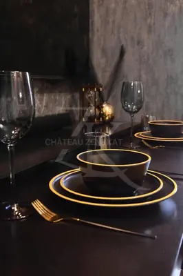 a table with a bowl and plates and glasses on it at Château Zen&Kat in Manila