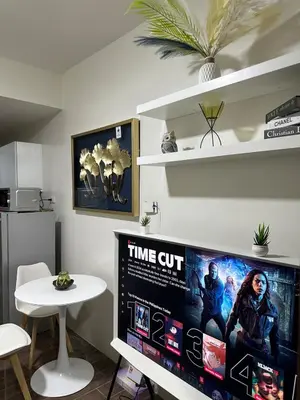 a living room with a large tv and a table at A King-size bed at Air Residences Condo, Ayala Ave, Makati in Manila