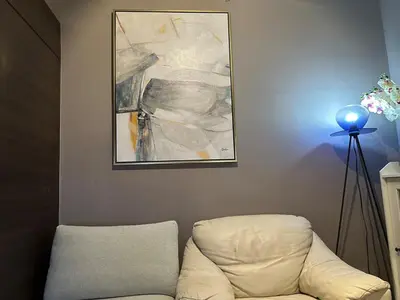a room with a couch and a painting on the wall at Air Residences Apartment, Ayala Avenue Makati in Manila