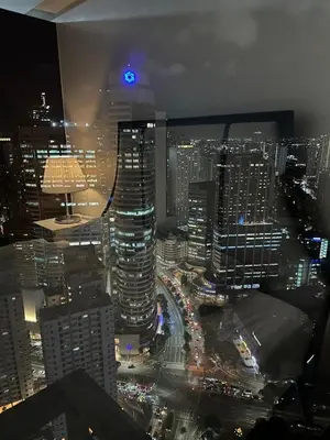 a view of a city skyline at night at King size bed at Air Residences Condo, Ayala Ave, Makati in Manila