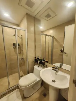 a bathroom with a toilet and a shower and a sink at Prime Location Walk to Nightlife! The Gramercy in Manila