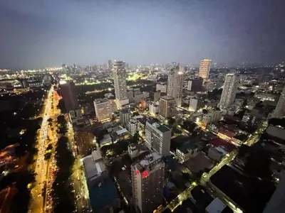 a city skyline at night with lit up buildings at Stunning 3BR with Sunset View near Dolomite Beach in Manila