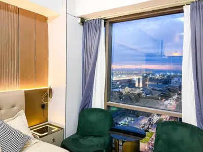 a room with a window with a view of a city at Stunning Sunset Retreat at Eton Bayview II 2pax in Manila