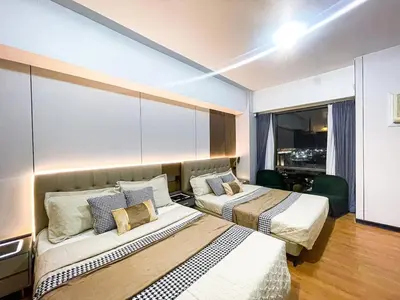 a hotel room with two beds and a window at Stunning Sunset Retreat at Eton Bayview II 2pax in Manila