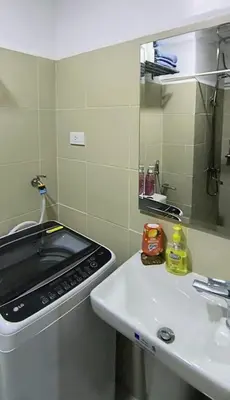 a kitchen with a sink and a stove at El Aris Lushly Inn in Manila