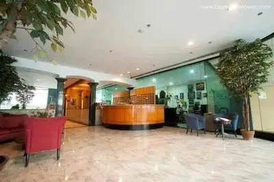 a lobby with chairs and a counter in a building at Sea View Condo in Manila