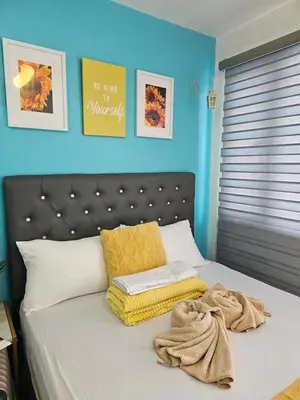 a bedroom with a bed with towels on it at CondoDeal at Shell Residences Mall of Asia in Manila