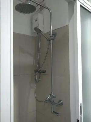 a shower with a shower head in a bathroom at CondoDeal at Shell Residences Mall of Asia in Manila