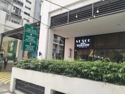 a street sign in front of a building at Nadzcondotel 2- at Two Palm Tree Villas o in Manila