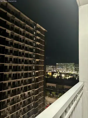 a view from the balcony of a building at night at New Oasis Staycation Shore 1 in Manila