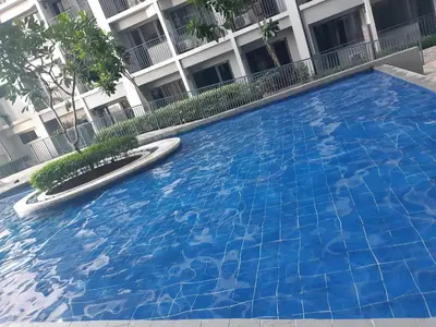 a large blue swimming pool in front of a building at Shore 2 tower 1 in Manila