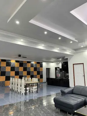 a living room with a couch and a table and chairs at Shiri Hotel Pool Villa 4 \uc26c\ub9ac\ud638\ud154 \ud480\ube4c\ub77c 4 in Silang