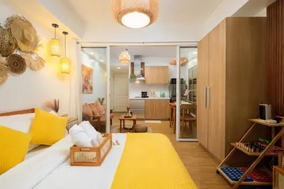 a bedroom with a bed and a living room at Azure Urban Resort Residences Parañaque City in Manila