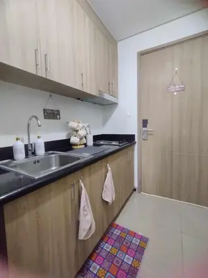 a kitchen with a sink and a sliding door at Shore 2 Residences by Casa Stellar mall of Asia Complex in Manila
