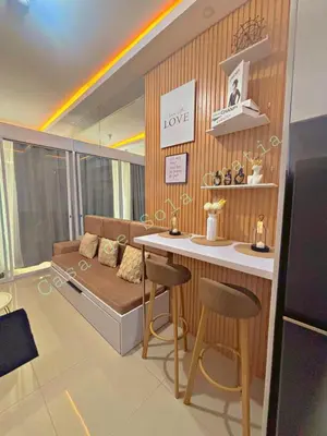 a living room with a couch and a table and chairs at Casa De Sola Gratia in Manila