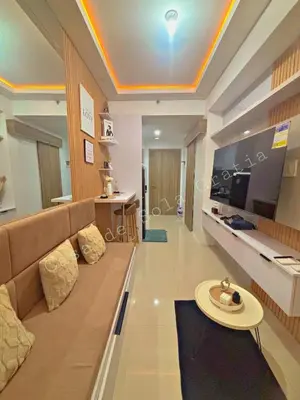 a living room with a couch and a flat screen tv at Casa De Sola Gratia in Manila