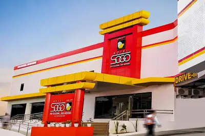 a gas station with a red and white building at Hotel Sogo Dasmariñas Cavite in Dasmariñas
