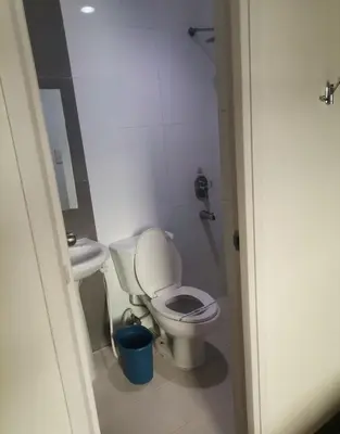 a small bathroom with a toilet and a sink at Hotel Sogo Dasmariñas Cavite in Dasmariñas