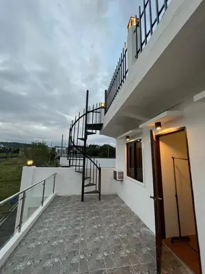 a staircase leading up to a house with a stair case at Casa Estela in Binangonan
