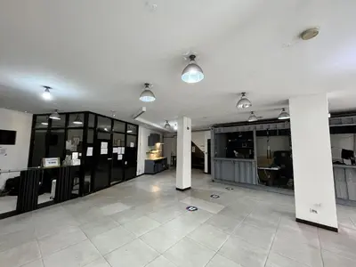 a large room with columns and lights in a building at Junction Hostel, Poblacion Makati Avenue, Manila in Manila