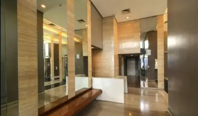 a hallway with a glass wall in a building at Minimalist Studio Condo - Alabang Near Airport in Manila