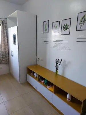a living room with a bench on the wall at Minimalist Studio Condo - Alabang Near Airport in Manila