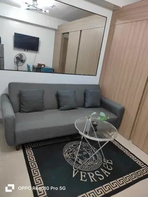 a living room with a couch and a table at G Spot Manila - Mall of Asia in Manila