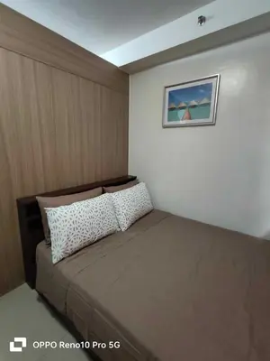 a bedroom with a bed with a picture on the wall at G Spot Manila - Mall of Asia in Manila
