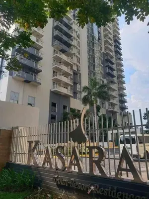a sign in front of a tall building at 1BR Apt in Manila