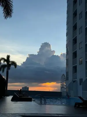 a view of the ocean from a building with a sunset at Condo in Pasay in Manila