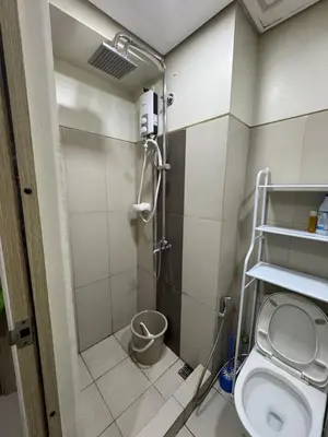 a bathroom with a shower and a toilet at Condo in Pasay in Manila