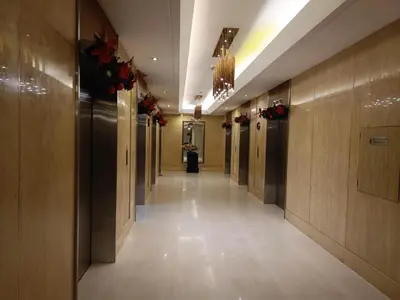 a hallway in a building with flowers on the walls at Affordable staycation in Pasay-Breeze Residence in Manila