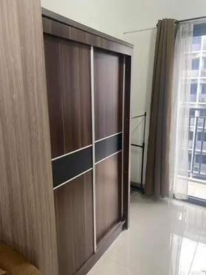 a large wooden door in a room with a window at Mall of Asia Staycation by Mochi - SMDC Shore 2 Tower 3 in Manila