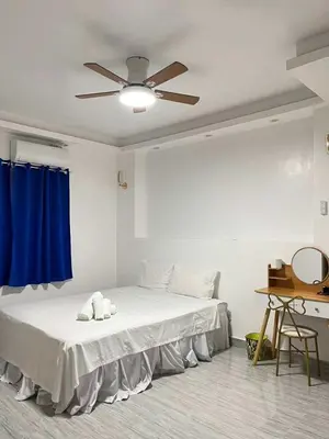 a bedroom with a bed with a ceiling fan at Shiri Pool Villa 1 in Silang