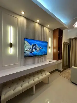 a living room with a couch and a tv at Ustays in comfort and style in Manila