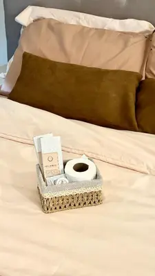 a bed with a book and a tray on it at Metroshore Azure 2 in Manila