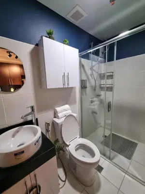 a bathroom with a toilet and a sink and a shower at AD Camp in Manila