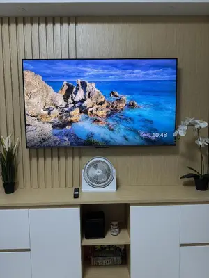 a flat screen tv sitting on top of a shelf at Shore Oasis Manila Near Mall of Asia in Manila