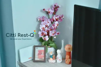 a vase of flowers sitting on a table next to a tv at Studio City Alabang Pool Access Free for 2 Wifi & Netflix SC3 in Manila