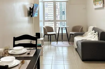 a living room with a couch and a table at Welcome to Jade Place at Pioneer Woodlands in Manila