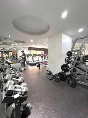 a gym with a bunch of equipment in a room at Sunset Studio in Manila