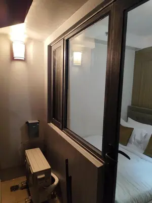 a room with a window and a bed and a bed sqor at Comfort Cove PH in Manila