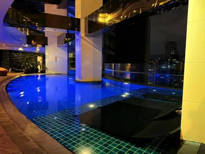 a swimming pool on top of a building at night at GRAMERCY - SKY-VIEW 1 Bed escape with POOL & SPA Access in Manila