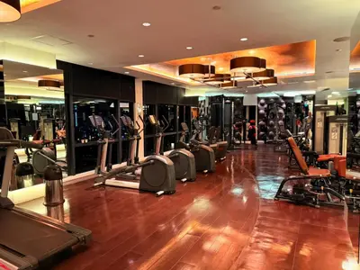 a gym with a bunch of treadmills and machines at GRAMERCY - SKY-VIEW 1 Bed escape with POOL & SPA Access in Manila