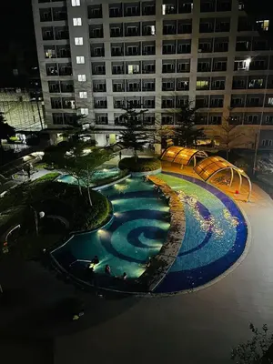 a large swimming pool in the middle of a building at Bali Inspired near BGC and NAIA in Manila