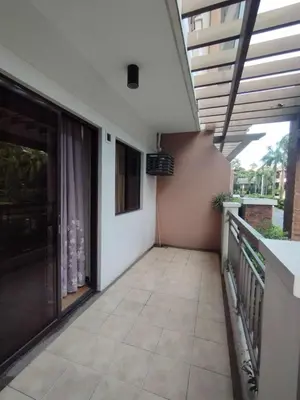 a balcony of a house with a patio at Siena Park by Casa Stellar Bicutan Paranaque in Manila