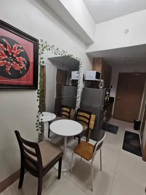 a kitchen and dining room with tables and chairs at aldo shore 3 residence mall of asia in Manila