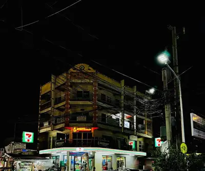 a building on a city street at night at Peaceful and cozy unit in Manila