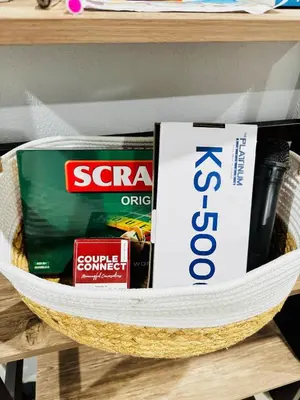 a basket on a shelf with books and other items at Peaceful and cozy unit in Manila