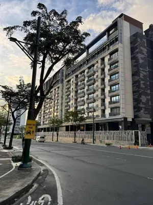 a large building on the side of a street at New 1BR Condo Near Venice Canal & BGC with Balcony - 7e in Manila